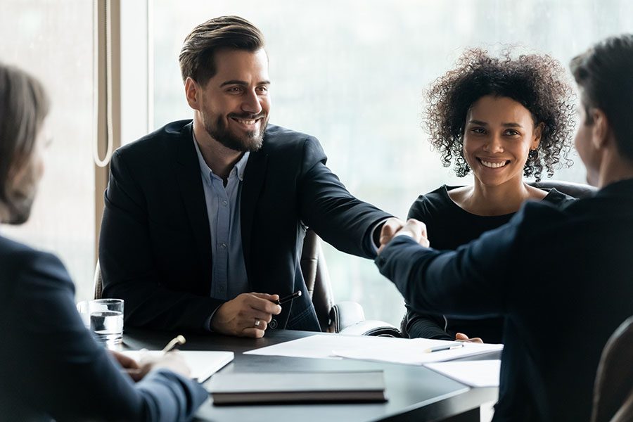 About Our Agency - Smiling Businessmen Shaking Hands During Meeting In Office