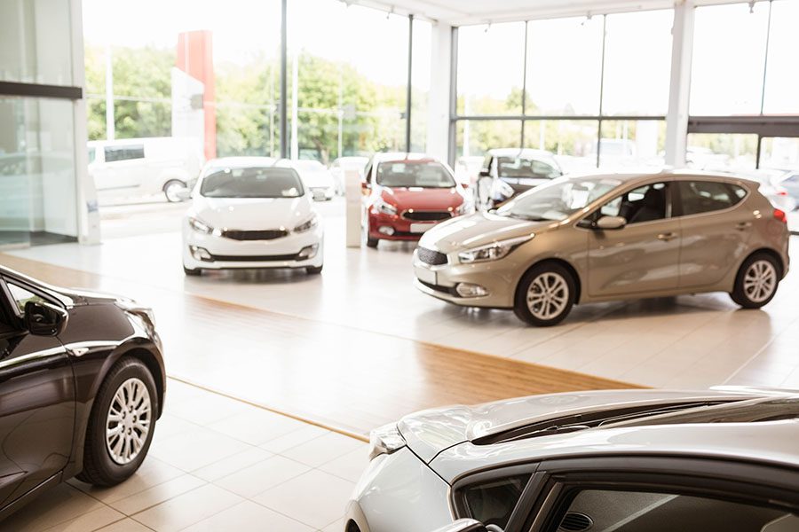 Specialized Business Insurance - Row Of Cars On Display Inside Car Dealership